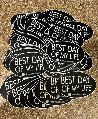 pile of black oval magnets that read best day of my life with a qr code